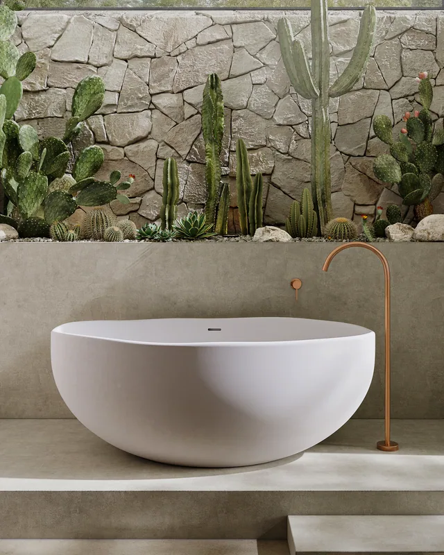 Stone bathroom set with a white tub, brushed copper