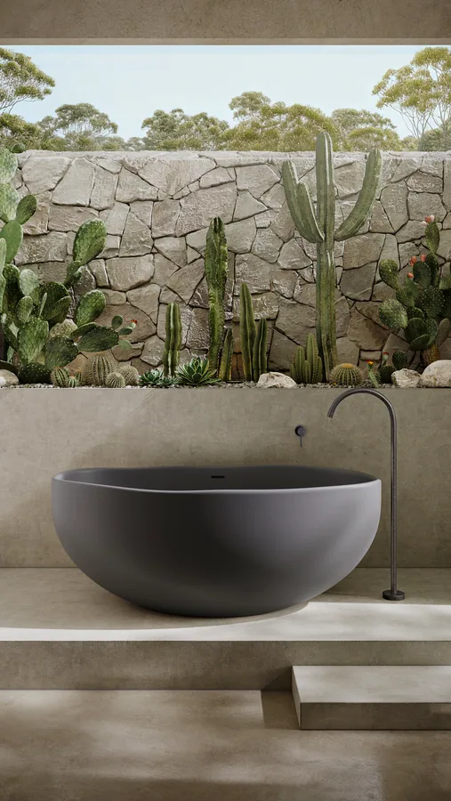 Outdoor bathroom in concrete with dark patina bath filler and cactus garden