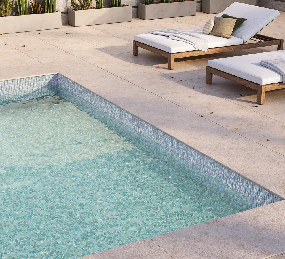 Pool with glass mosaic coping tiles and sun loungers