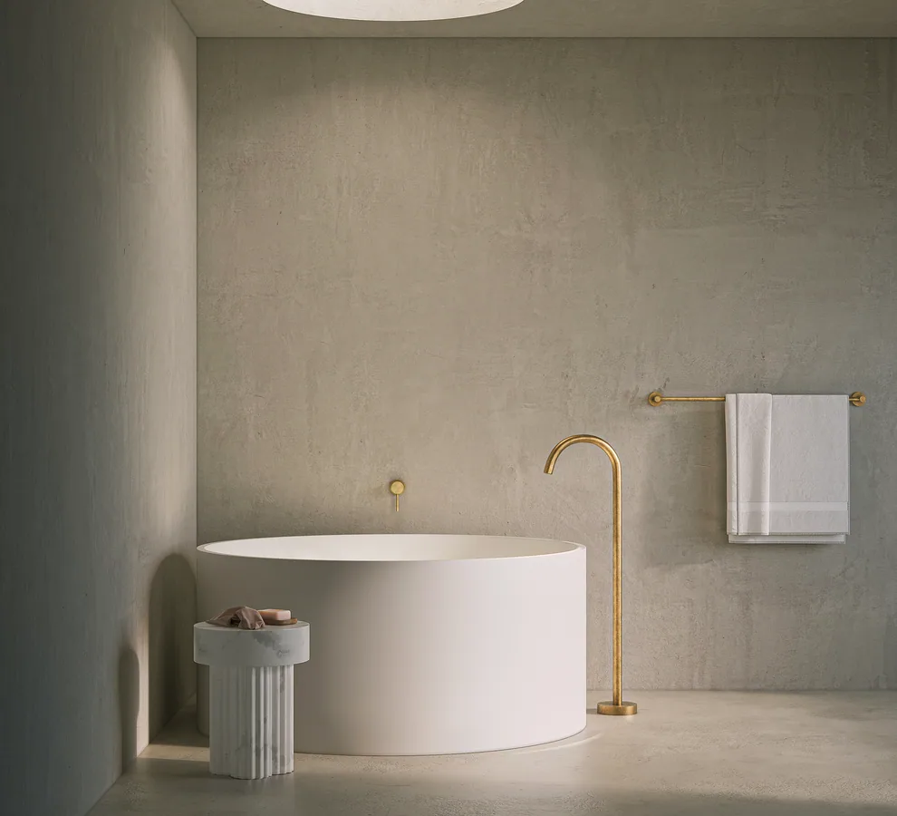 Freestanding bath with aged brass floor-mounted filler